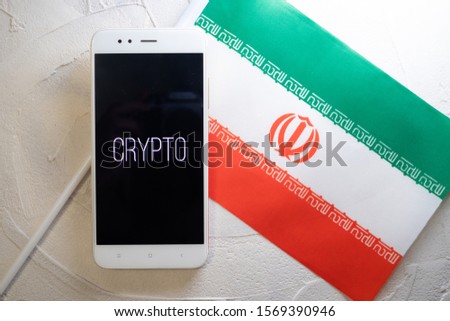 Cryptocurrency and government regulation, concept. Modern economy, smartphone with bitcoin sign on the screen on the background of the flag of Iran