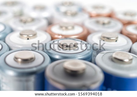 Energy abstract background of colorfu lithium rechargeablel batteries. Close up top view on rows of selection of Ni-MH AA batteries. Several batteries are next to each other. Royalty-Free Stock Photo #1569394018