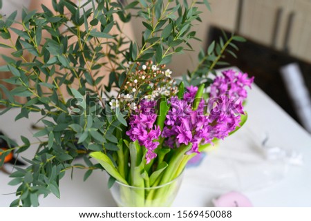 photo from a series of pictures about the process of forming a fruit and flower bouquet. tutorial, do it yourself. photo 3, pink hyacinth, chamelaucium and sprigs of eucalyptus in a vase