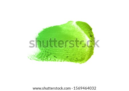 Smear and texture of lipstick or acrylic paint isolated on white background. Stroke of lipgloss or liquid nail polish swatch smudge sample. Element for beauty cosmetic design. Green yellow color