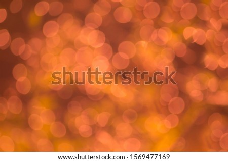 Abstract background. Distribution of white bokeh on delicate gold backgrounds.