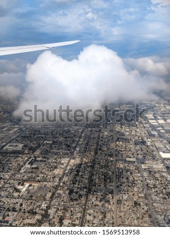View from aircraft on Los Angeles city. Big cloud over the city. USA