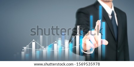Businessman plan graph growth and increase of chart positive indicators in his business Royalty-Free Stock Photo #1569535978