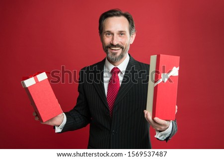 Boxing day sale. Happy manager prepare gifts for boxing day. Mature man celebrate boxing day. Giving gifts and presents. Merry Christmas. Prosperous New year. Happy boxing day. Its giveaway time.
