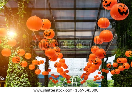 Hanging Jack O'Lantern of pumpkin dolls from the outdoor ceiling to celebrated on Halloween day with lighting.