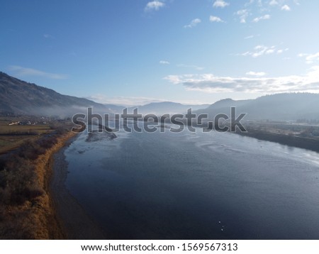 Beautiful view of a river. This picture is set under a blue sky in late fall. 