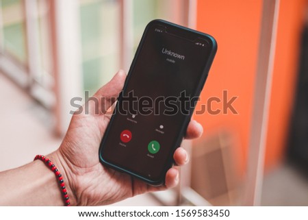 Unknown caller on the screen of phone Royalty-Free Stock Photo #1569583450