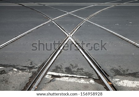 Transportation background with tramway crossing on gray asphalt urban road