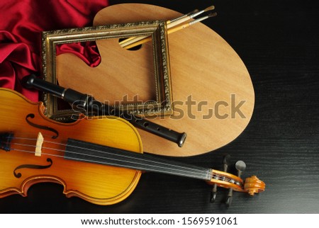 Art attributes. Music, painting. Violin, flute, art palette. brushes, picture frame. On a black background