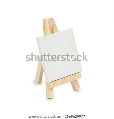 Miniature easel with blank canvas isolated on a white background. Side view.
