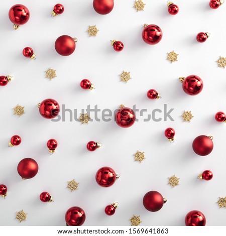 Christmas minimal pattern - red xmas ball and gold snowflake on white background. Square composition. Flat lay, top view. Red, gold and white pattern
