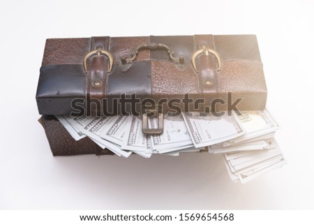 open a chest with a lot of money dollar bills lit by magic light. Concept of wealth and abundance.