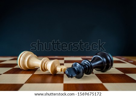 Chess pieces on a chessboard. Symbolic meaning. Beautiful figures on a black background.