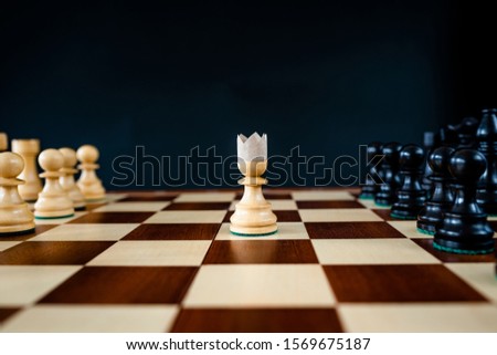 Chess pieces on a chessboard. Symbolic meaning. Beautiful figures on a black background.