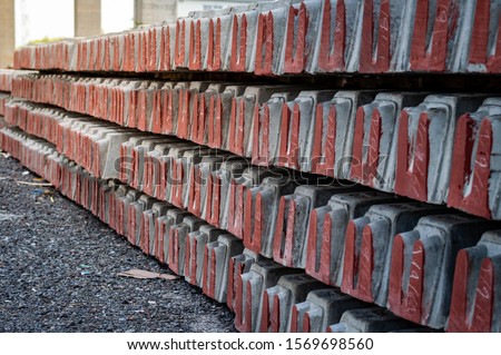 Background and Texture of piled concrete sleeper at train station.Pile of precast concrete sleepers ready for construction in trackwork.Sleepers made of concrete laid in a row for rails.