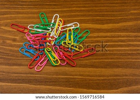 Pile of colorful paper clips on a desk