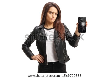 Sad young woman holding a broken mobile phone isolated on white background