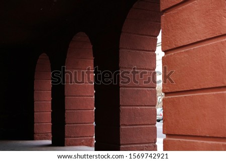 Arches in houses made of red stone and carp. Walkways in the houses