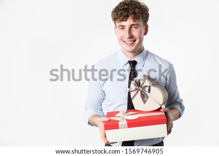 Young man with gifts in hands on a white background.