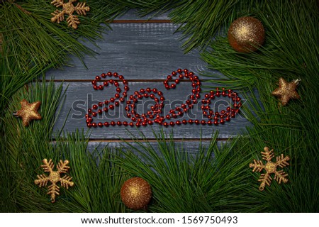 Christmas flat barking numbers 2020 made of red garland decorated with cedar branches with New Year's gold balls of different colors. Mock up for Santa Claus letter and Christmas designs