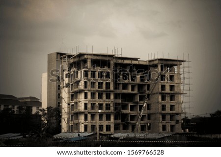 A black and white picture of a building that is currently being built.