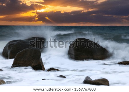 Dramatic sunset over the stormy sea. Summer vacation on tropical resort