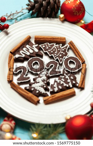New Year and Christmas chocolate gingerbread cookies in silhouette of 2020. Homemade delicious bakery, sweet family time and traditions.