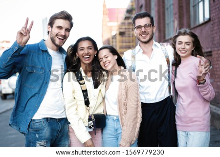 Group of young people having fun together outdoors. City lifestyle and party concept