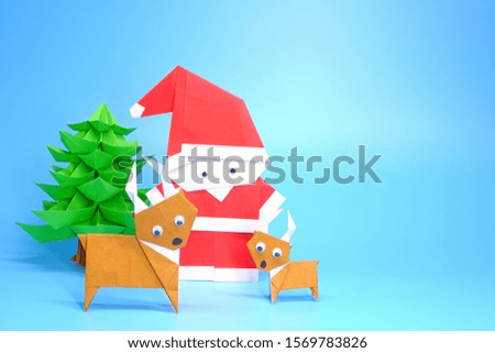 Origami paper art : Santa Claus, reindeer and Christmas tree for greeting season of Christmas and New year. Copy space