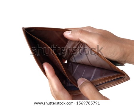 Two hands is opening brown wallet that have nothing inside, saving and financial planning concept. 