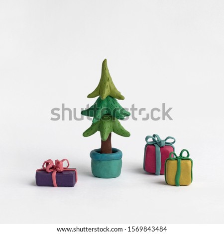 Christmas tree and gifts on a white background. Plasticine illustration Royalty-Free Stock Photo #1569843484