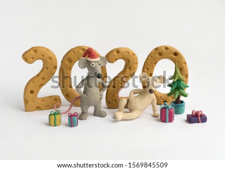 Plasticine illustration with two mice, gifts, Christmas tree and number 2020