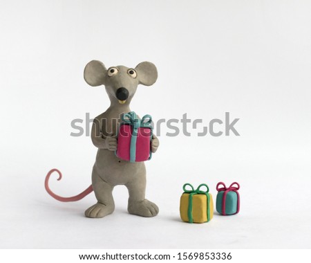 Plasticine character mouse with gifts on a white background Royalty-Free Stock Photo #1569853336