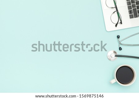 Top view of doctor's desk with laptop. Doctor's work tools, medical equipment. Modern medicine concept