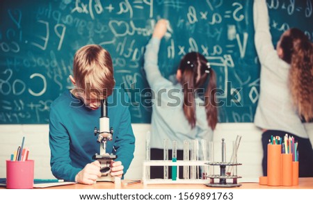 Doing research. Little kids learning chemistry in school lab. Little children at laboratory. Chemistry microscope. students doing biology experiments with microscope. Lab microscope. childrens day.