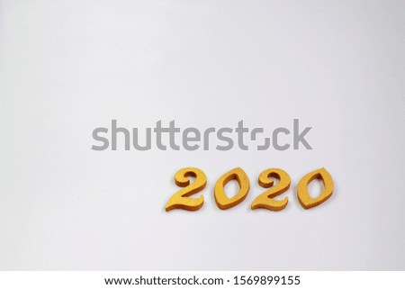 Happy new 2020 year. Gold wooden numbers 2020 on the white background