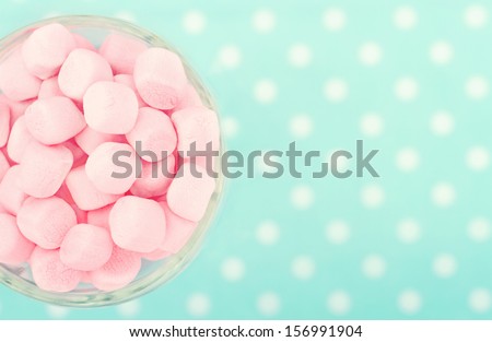 Pink marshmallows on polkadot blue blurred background with vintage nostalgic editing Royalty-Free Stock Photo #156991904