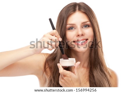 Woman applying face powder, isolated on white background