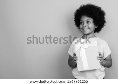 Young cute African girl with Afro hair in black and white