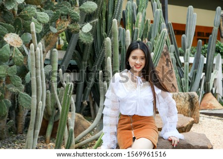 Portrait asian woman wearing white shirt and brown skirt in cact