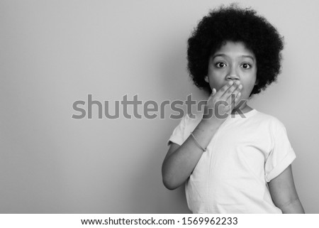 Young cute African girl with Afro hair in black and white