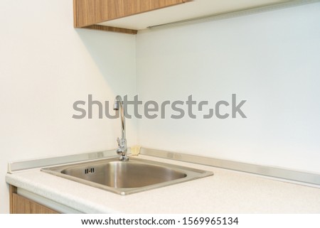 Water faucet and sink decoration in the kitchen interior room