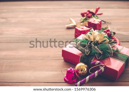 Top view of Christmas composition with gift boxes, ball on wooden background and copy space. Accessories of Christmas and new year concept.