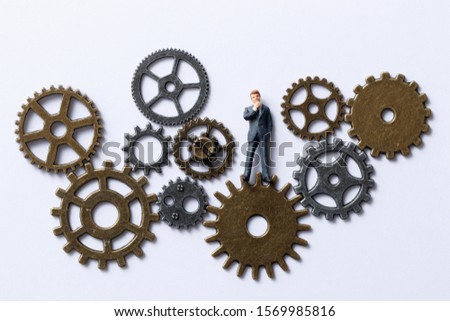 Businessman doll in a lot of gears