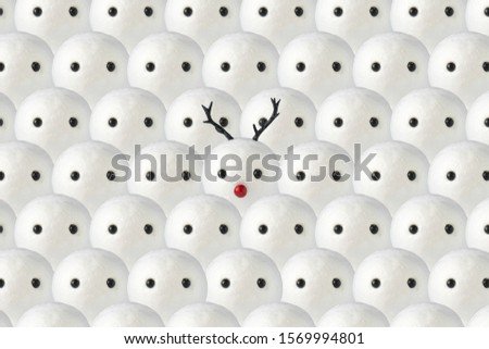 Snowmen background with one snowman with Christmas reindeer antlers. Minimal winter holidays concept.