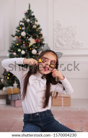 Christmas portrait of a beautiful girl with long blond hair in a playful mood depicts different emotions