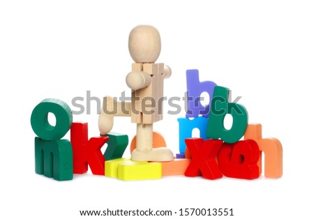 Wooden man figure, mannequin with colorful alphabet, spelling letters isolated on white background