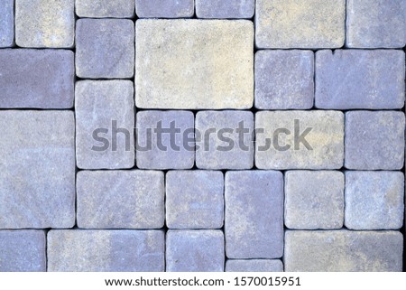 colored paving slabs by mosaic, closeup. Road paving construction. Tessellated sidewalk tile
