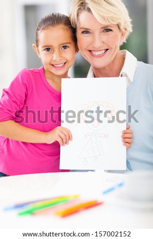 cute little girl showing drawing picture of her grandma