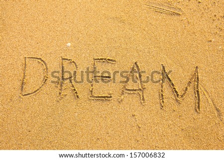 Dream - Inscription on the sand texture.
